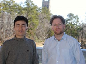 Two men pose in front of Duke Chapel